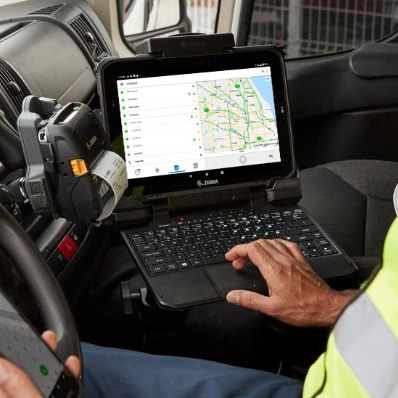 Worker using tablet with keyboard with map on the screen